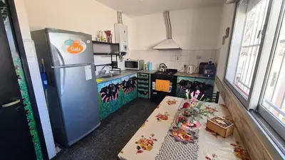a kitchen with a refrigerator and a table in it at El Tesoro Cordobés in Cordoba