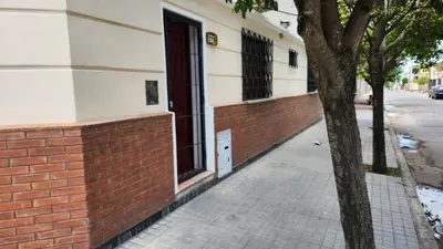 a brick sidewalk next to a building with a tree at El Tesoro Cordobés in Cordoba
