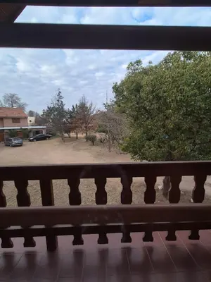 a view of a park from a balcony at Cabaña Dario in Villa Independencia