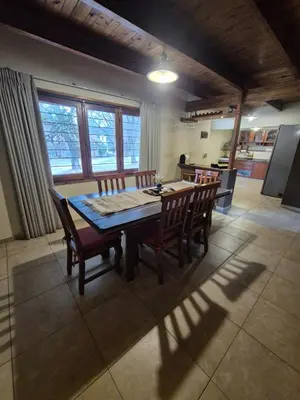 a dining room table and chairs in a kitchen at Cabaña Dario in Villa Independencia