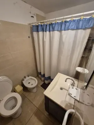 a bathroom with a toilet and a sink at Cabaña Dario in Villa Independencia