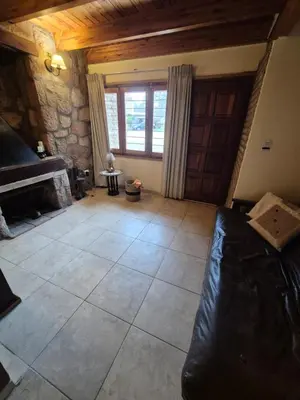 a living room with a couch and a fireplace at Cabaña Dario in Villa Independencia