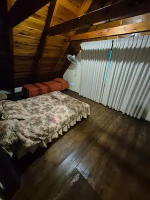 a bedroom with a bed in a attic at Cabaña Dario in Villa Independencia