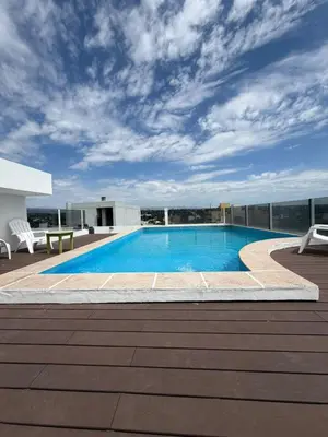 a swimming pool on the roof of a building at Departamento Carilo in Villa Carlos Paz