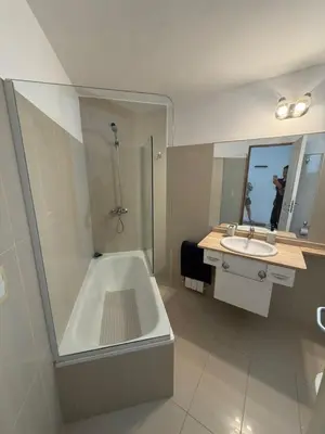 a bathroom with a shower and a tub and a sink at Departamento Carilo in Villa Carlos Paz