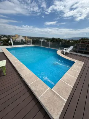 a swimming pool on the roof of a building at Departamento Carilo in Villa Carlos Paz