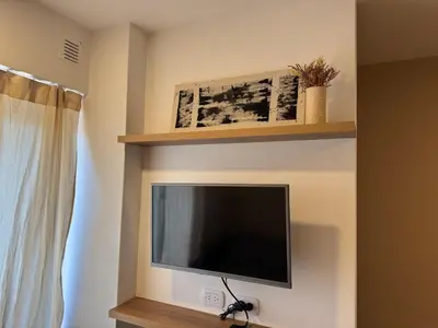 a flat screen tv on a wall in a room at Departamento Nueva Córdoba in Cordoba