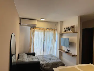 a small bedroom with a bed and a window at Departamento Nueva Córdoba in Cordoba