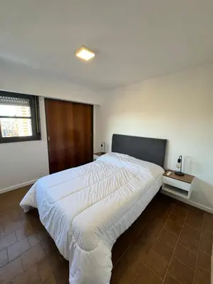 a bedroom with a large white bed in it at Departamento Nueva Córdoba in Cordoba