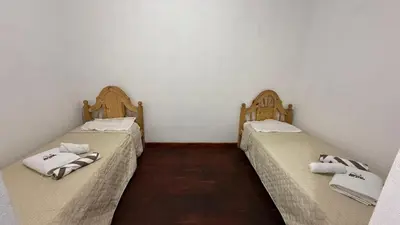 two twin beds in a room with at Refugio del Alma in Villa Anizacate
