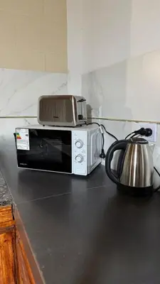 a toaster oven sitting on top of a microwave at Refugio del Alma in Villa Anizacate