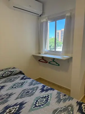 a bedroom with a bed and a window at Amelia 2-4 in Villa Carlos Paz