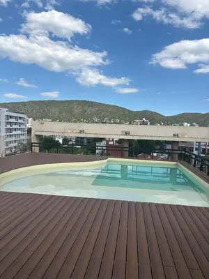 a swimming pool on the roof of a building at Amelia 2-4 in Villa Carlos Paz