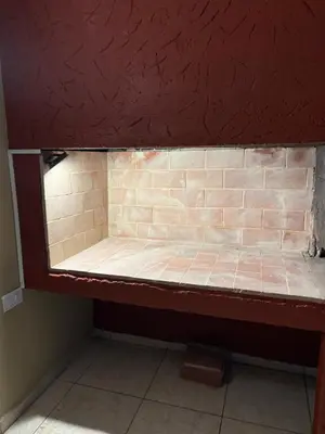 a bed in a room with a brick wall at Amelia 2-4 in Villa Carlos Paz