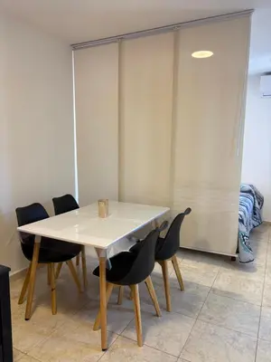 a dining room with a table and chairs at Amelia 2-4 in Villa Carlos Paz