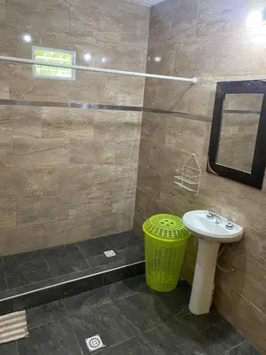 a bathroom with a sink and a shower with a mirror at Short-Term Rental in Bialet Massé