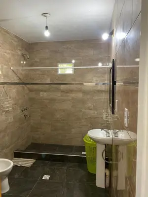 a bathroom with a sink and a shower and a toilet at Short-Term Rental in Bialet Massé