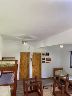 a room with two bunk beds and wooden walls at Short-Term Rental in Bialet Massé