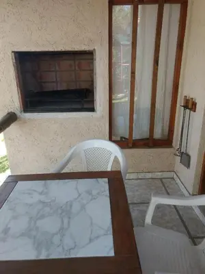 a table and two chairs in front of a window at Tierra Nuestra in Villa Ciudad de America