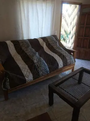 a bed with a blanket on it in a room at Tierra Nuestra in Villa Ciudad de America