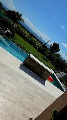 a swimming pool with a red frisbee next to it at Hermosa casa en Anisacate in Villa Anizacate