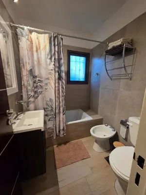 a bathroom with a sink and a toilet and a tub at Hermosa casa en Anisacate in Villa Anizacate