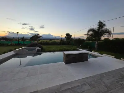 a swimming pool with a bench in a yard at Hermosa casa en Anisacate in Villa Anizacate