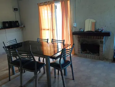 a dining room with a table and chairs and a fireplace at Casa de luna in San Lorenzo
