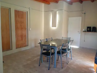 a dining room with a table and chairs at Casa de luna in San Lorenzo