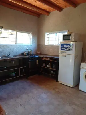 a kitchen with a white refrigerator and a sink at Casa de luna in San Lorenzo