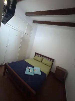 a bedroom with a bed with two books on it at Colonia 25 de Mayo in Villa Carlos Paz