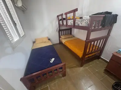 a room with two bunk beds in a room at Colonia 25 de Mayo in Villa Carlos Paz