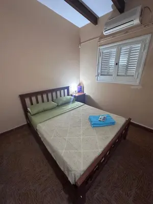 a bedroom with a bed with a blue tray on it at Colonia 25 de Mayo in Villa Carlos Paz