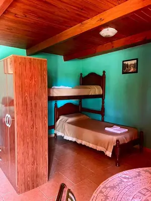 two bunk beds in a room with green walls at Cabaña Garcia in Santa María