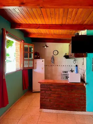 a kitchen with a counter and a white refrigerator at Cabaña Garcia in Santa María