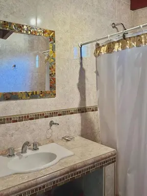 a bathroom with a sink and a shower curtain at Cabaña Garcia in Santa María