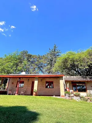a house with a grass field in front of it at Cabaña Garcia in Santa María