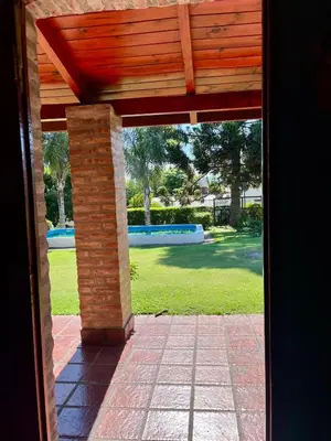 an open door to a patio with a wooden roof at Cabaña Garcia in Santa María
