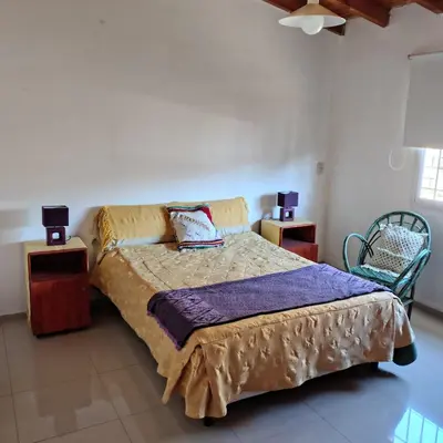 a bedroom with a bed and two night stands at La casita de Otto in Santa María