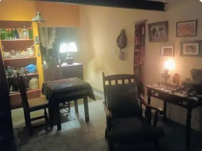 a living room with a table and a chair at La casa de Ale in Cordoba