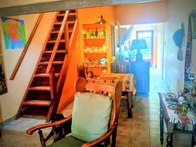 a room with a staircase and a table with a dining room at La casa de Ale in Cordoba