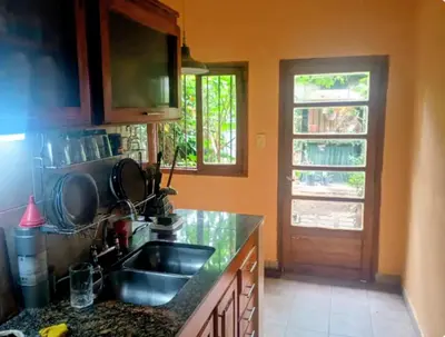 a kitchen with a sink and a window and a door at La casa de Ale in Cordoba