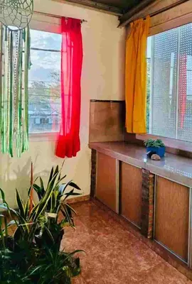 a room with red and yellow curtains and a window at Colorido departamento planta alta in Río Tercero