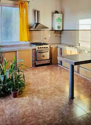 a kitchen with a sink and a stove at Colorido departamento planta alta in Río Tercero