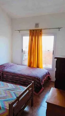 a bedroom with a bed and a window at Colorido departamento planta alta in Río Tercero