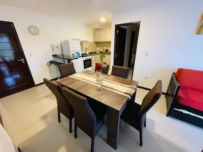 a dining room table and chairs in a room at Veneto Village Dpto T3 1 K in Villa Parque Siquiman