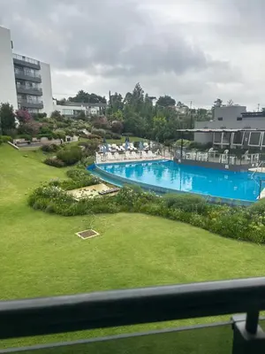 a view of a swimming pool from a balcony at Veneto Village Dpto T3 1 K in Villa Parque Siquiman