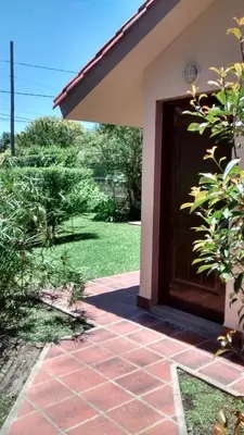 a entry door to a house with a patio at Casita del Lago in Villa Carlos Paz