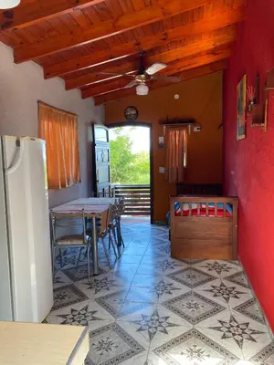 a kitchen and dining room with a table and a refrigerator at Departamento El Delfín in Tanti
