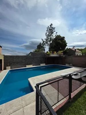 a swimming pool in the backyard of a house at Complejo de departamentos 7 Cielos in Villa Carlos Paz